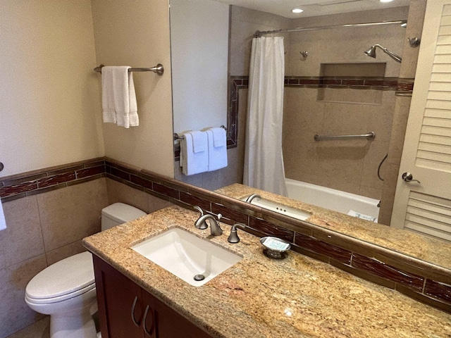 2481 Kaanapali Pkwy Unit 101A, Lahaina, HI 96761 - bathroom with tile walls, toilet, vanity, shower / bath combo with shower curtain, and a wainscoted wall