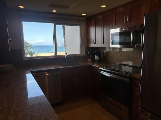 2481 Kaanapali Pkwy Unit 101A, Lahaina, HI 96761 - kitchen with appliances with stainless steel finishes, a sink, recessed lighting, tasteful backsplash, and dark brown cabinets