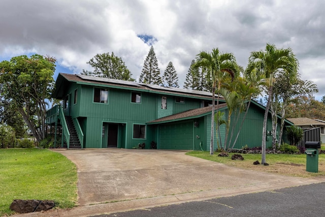 2751 Aina Lani Dr, Pukalani, HI 96768 - view of front facade with a garage, solar panels, a front lawn, stairway, and concrete driveway