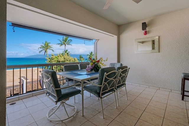 sunroom with a water view and a view of the beach