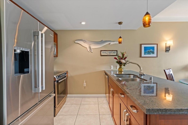 kitchen with hanging light fixtures, dark stone counters, sink, crown molding, and stainless steel appliances