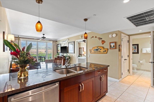 kitchen featuring dishwasher, pendant lighting, and dark stone counters