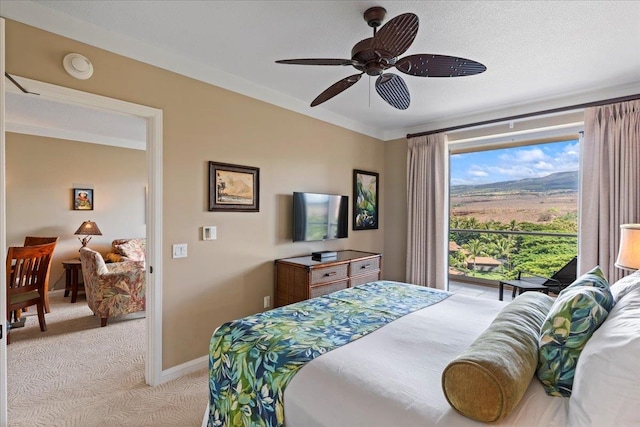 bedroom featuring light carpet, ornamental molding, and ceiling fan