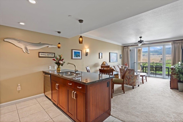 kitchen featuring hanging light fixtures, sink, light tile patterned flooring, stainless steel dishwasher, and ceiling fan