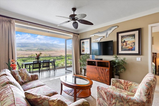 carpeted living room with a textured ceiling and ceiling fan