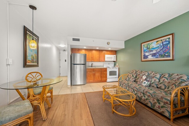 living room featuring sink and light wood-type flooring