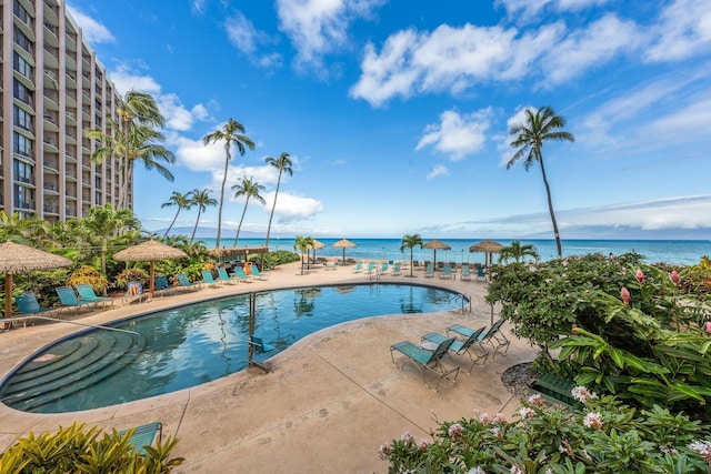 view of swimming pool featuring a patio area and a water view