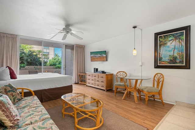 living room featuring hardwood / wood-style floors, floor to ceiling windows, and ceiling fan