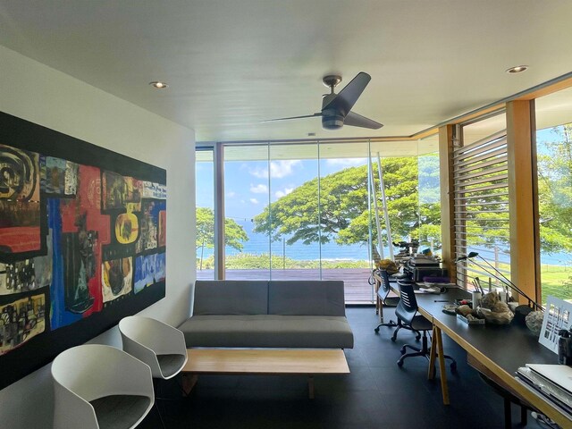 sunroom with a water view and ceiling fan