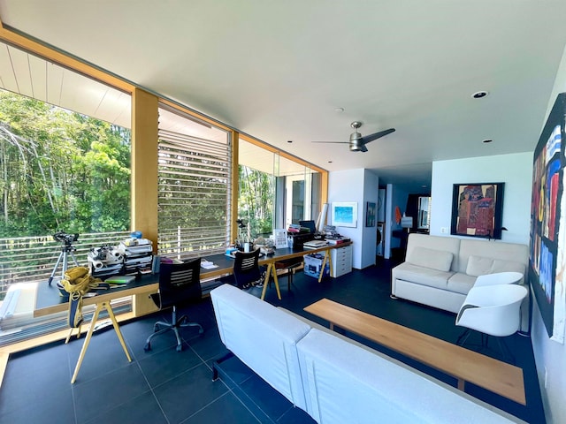 living room with dark tile patterned flooring, a healthy amount of sunlight, and ceiling fan