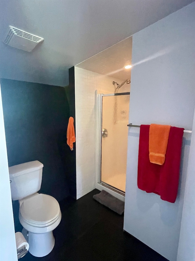 bathroom featuring toilet and walk in shower