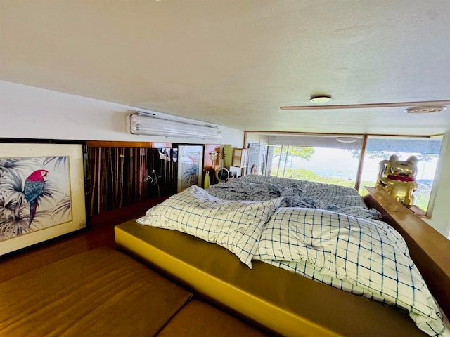 bedroom featuring a textured ceiling and wood-type flooring