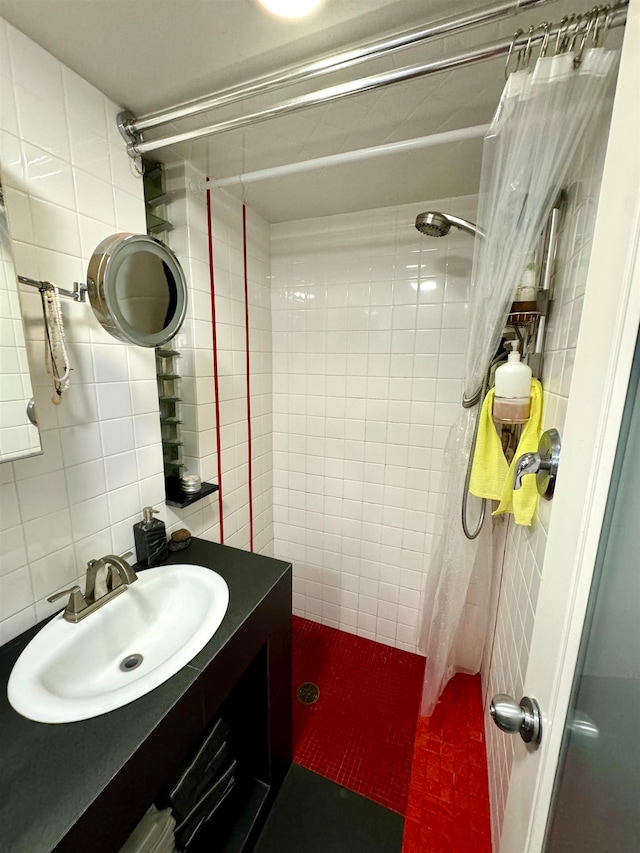 bathroom with a shower with shower curtain, tile walls, and vanity