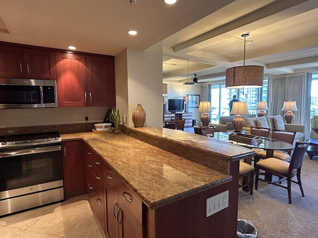 kitchen with appliances with stainless steel finishes, a peninsula, open floor plan, light stone countertops, and recessed lighting
