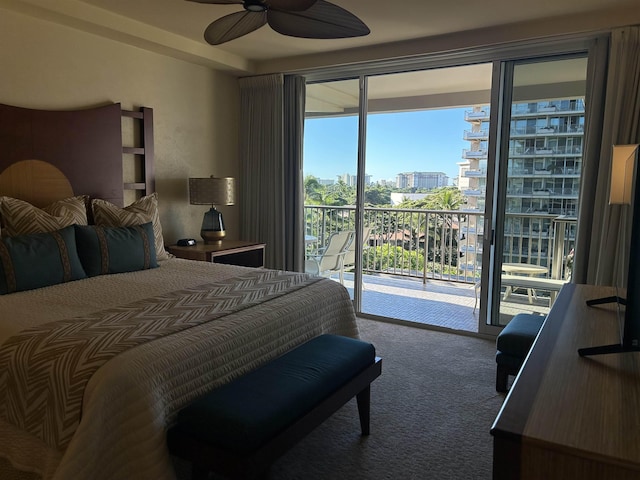 bedroom with carpet, access to outside, a view of city, and a ceiling fan