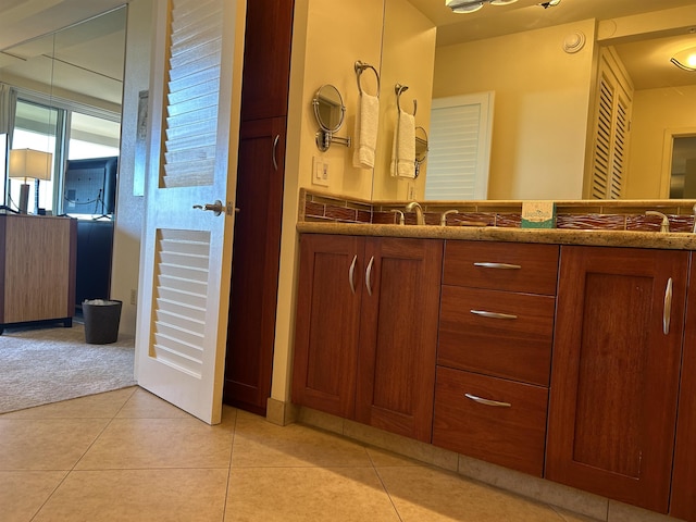 bathroom with tile patterned flooring and double vanity