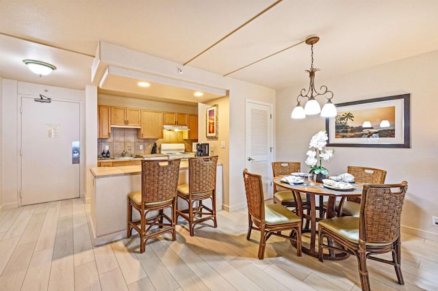 4327 Lower Honoapiilani Rd Unit 101B, Lahaina, HI 96761 - dining area with light wood-style floors, baseboards, and recessed lighting