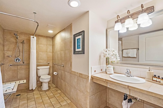 4327 Lower Honoapiilani Rd Unit 101B, Lahaina, HI 96761 - bathroom with a sink, toilet, tile walls, a tile shower, and tile patterned flooring