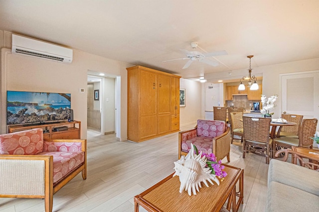 4327 Lower Honoapiilani Rd Unit 101B, Lahaina, HI 96761 - living room featuring a wall mounted AC, ceiling fan, light wood-style floors, and a chandelier
