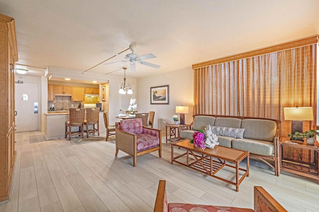 4327 Lower Honoapiilani Rd Unit 101B, Lahaina, HI 96761 - living room featuring ceiling fan, light wood-style flooring, and a chandelier