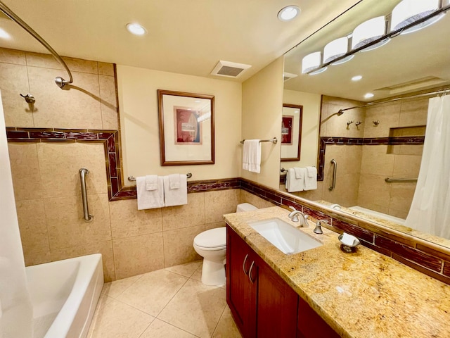 full bathroom featuring shower / tub combo with curtain, vanity, tile patterned floors, tile walls, and toilet