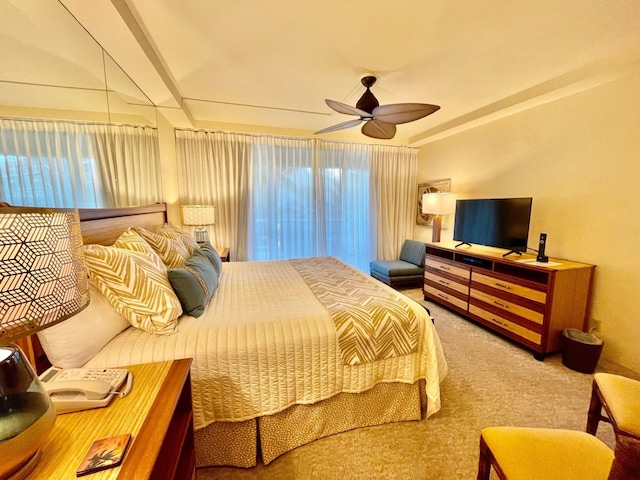 bedroom with ceiling fan, carpet, and multiple windows