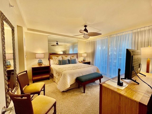 bedroom with ceiling fan and light carpet