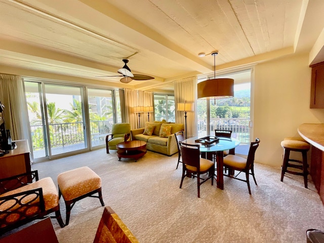 carpeted dining area featuring ceiling fan