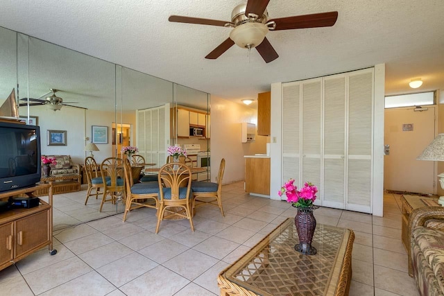 73 N Kihei Rd Unit 306, Kihei, HI 96753 - dining room with a ceiling fan, light tile patterned floors, and a textured ceiling