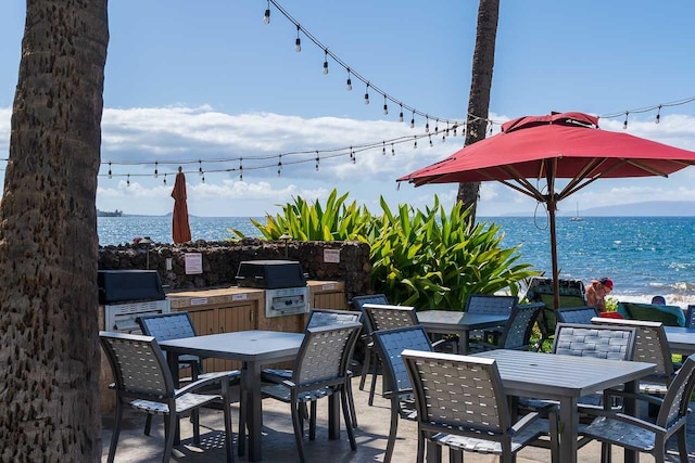 view of patio featuring a water view and area for grilling