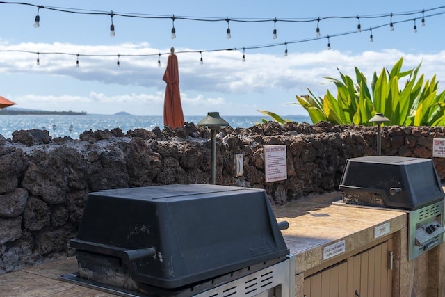 73 N Kihei Rd Unit 306, Kihei, HI 96753 - view of patio / terrace featuring grilling area and a water view