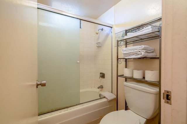 bathroom with enclosed tub / shower combo and toilet