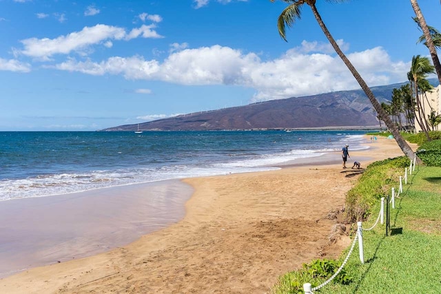 view of water feature with a mountain view and a beach view