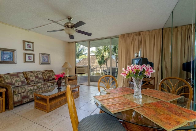 tiled dining room featuring ceiling fan and a textured ceiling