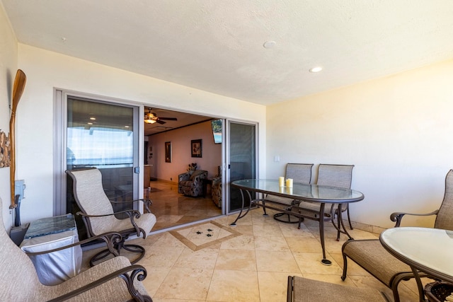 interior space with ceiling fan and light tile patterned flooring