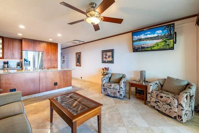 living room featuring ceiling fan and crown molding