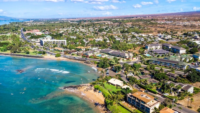 bird's eye view featuring a view of the beach and a water view