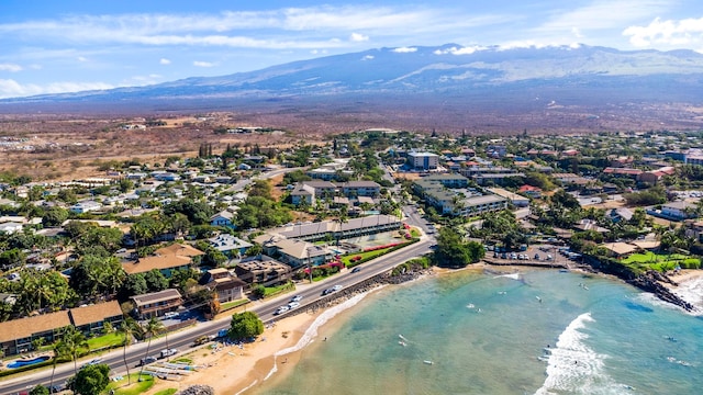 aerial view with a water and mountain view and a beach view