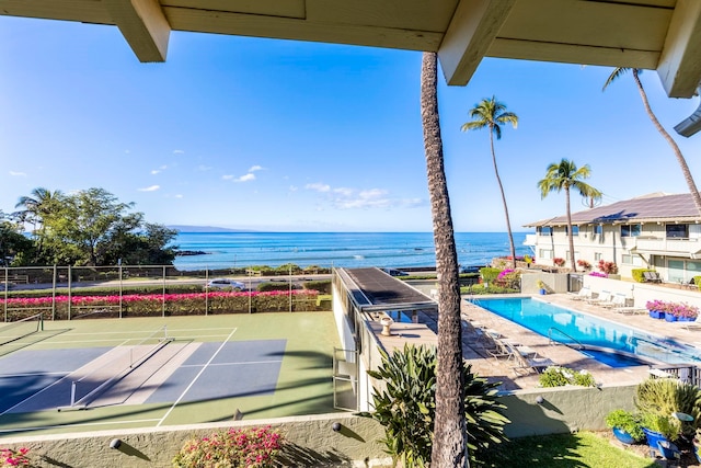 exterior space featuring a water view and tennis court