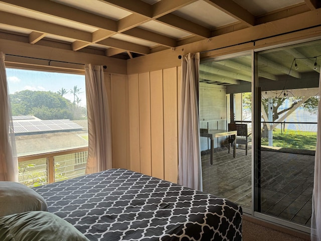 bedroom featuring coffered ceiling, multiple windows, and beamed ceiling