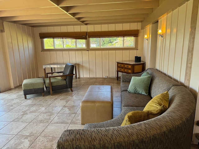 living room with beamed ceiling and light tile floors