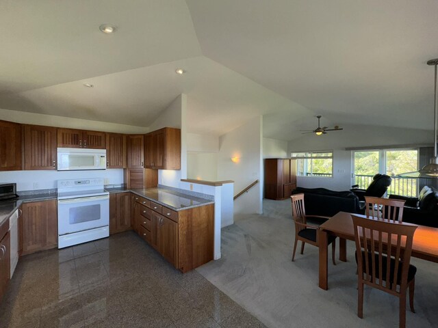 carpeted dining room with lofted ceiling