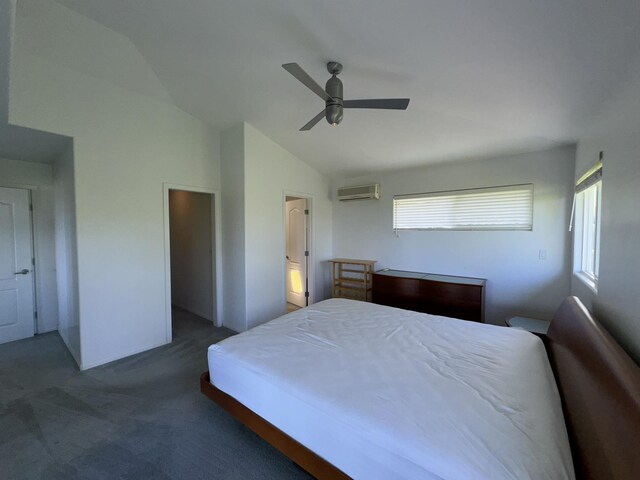 carpeted bedroom with ceiling fan, vaulted ceiling, and an AC wall unit