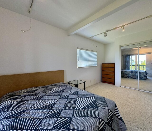 sitting room featuring beam ceiling, ceiling fan, light colored carpet, and plenty of natural light