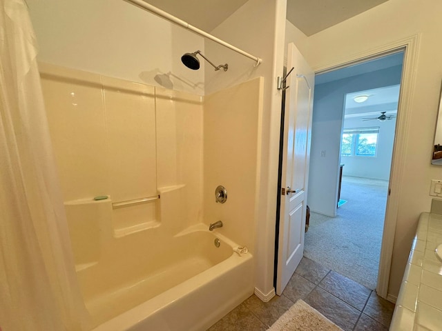 bathroom with ceiling fan, shower / bathtub combination, and tile patterned floors