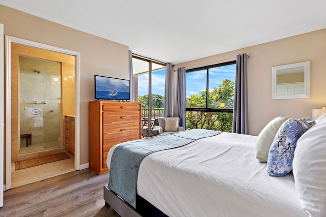 bedroom featuring hardwood / wood-style flooring and connected bathroom