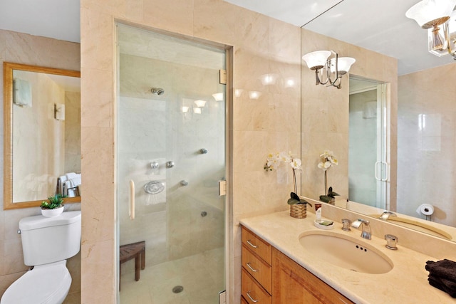 bathroom featuring tile walls, an enclosed shower, vanity, and toilet