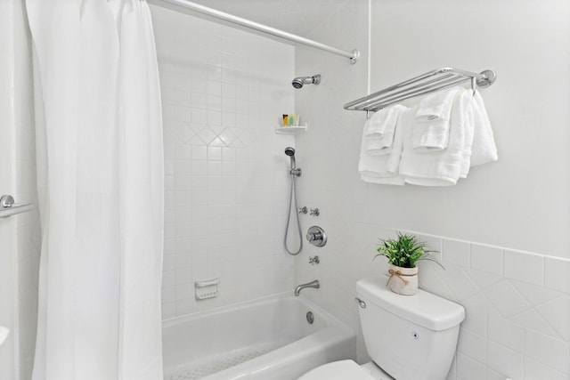 bathroom with shower / tub combo with curtain and toilet