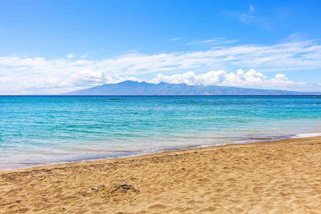 water view featuring a mountain view and a beach view