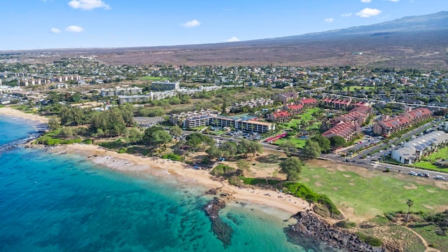 aerial view with a water view and a beach view